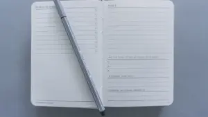 Otwarty dziennik postępów z listą zadań na białym papierze